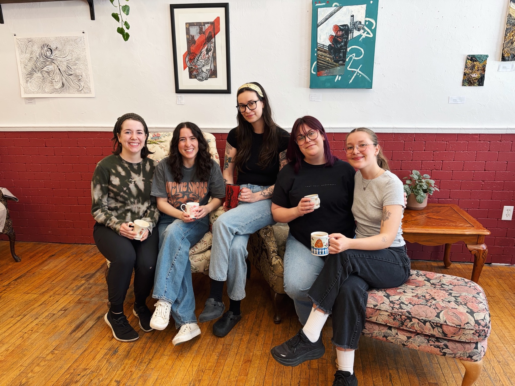 Five members of the Our Place Coffeehouse team together inside the café