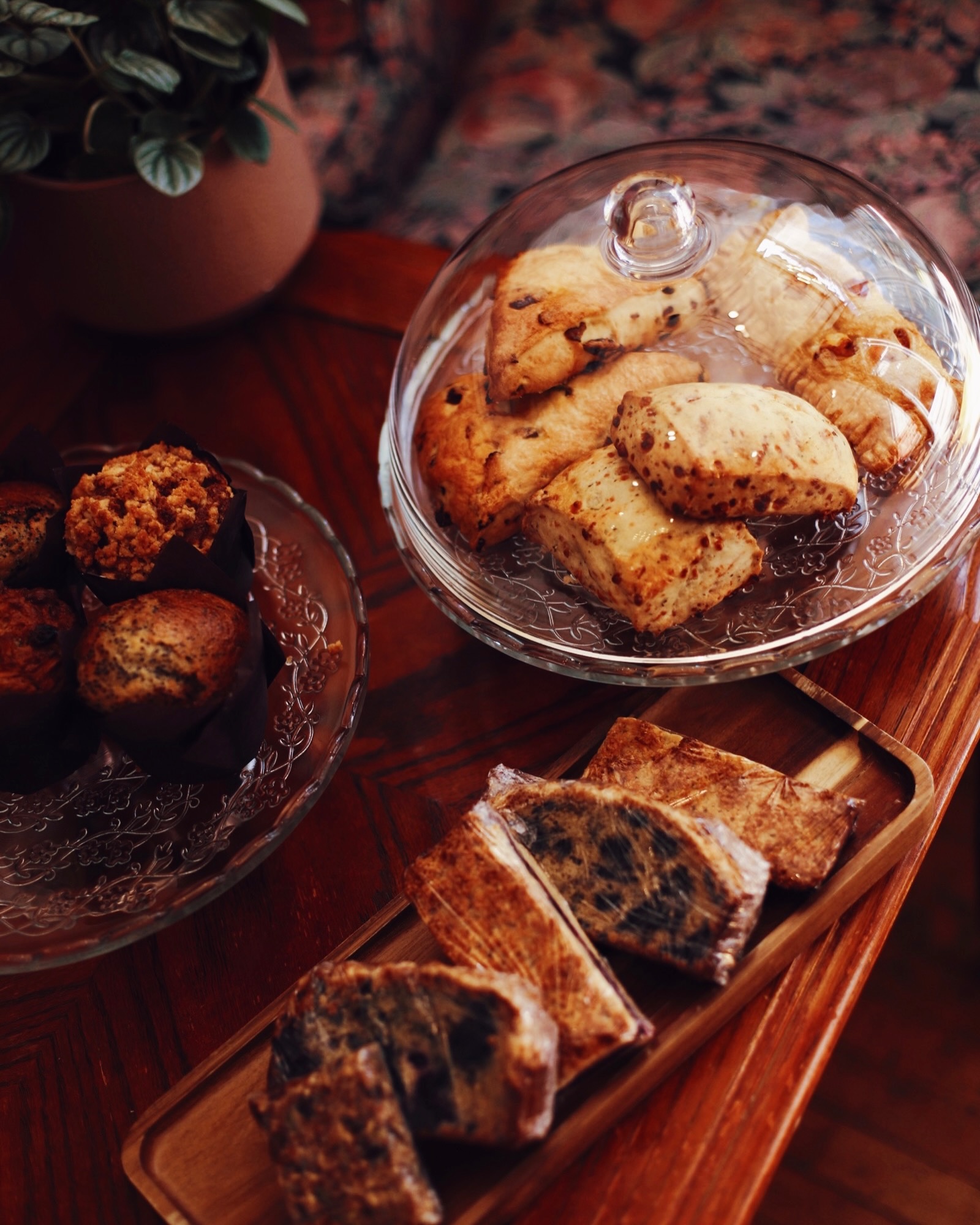 Fresh pastries displayed beside a patterned armchair inside Our Place